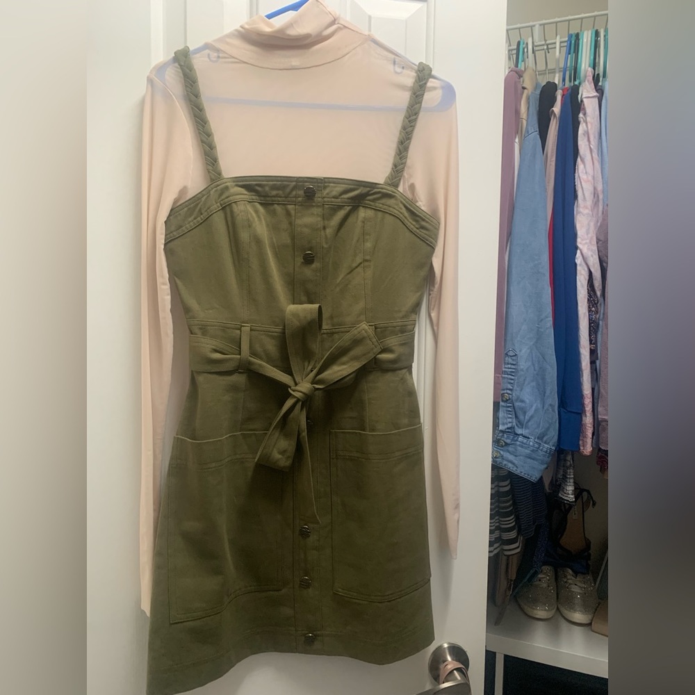 Green mini dress with tan netting turtle neck underneath